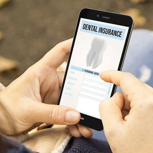 Patient looking at dental insurance forms on smartphone