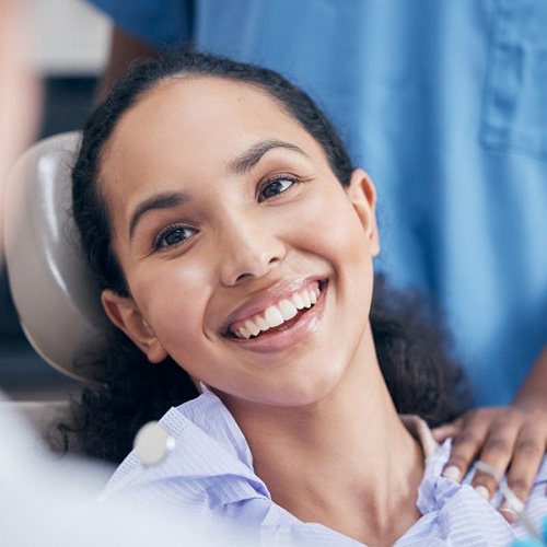 a patient smiling while visiting her dentist